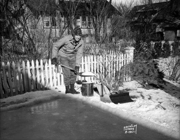 Arnold S. Zander making slush for ice skating rink border at 175 Virginia Terrace.