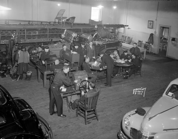 Fire fighters taking five different driving safety tests administered by Wisconsin Motor Vehicle Safety Department employees in Fire Station #1, 18 South Webster Street.