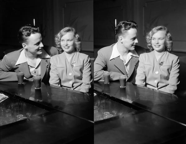 Two views of a couple sitting at soda fountain, featuring his and her lapel jewelry.