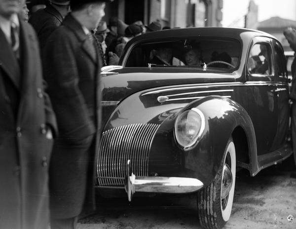 Group of people near a Ford automobile, on the occasion of Governor Julius P. Heil's inauguration.