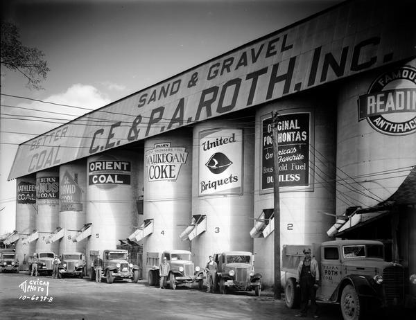 Seven coal delivery trucks and six drivers parked in front of eight different coal silos (Kathleen, Enos, St. David, Orient, Waukeegan, United, Pocahontas and Reading brands) at the C.E. & P.A. Roth, Inc., 1208 Roth Street.