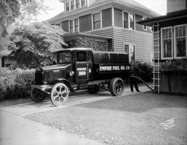 Empire Fuel Company truck, with a man delivering fuel to a house at 1721 Regent Street.