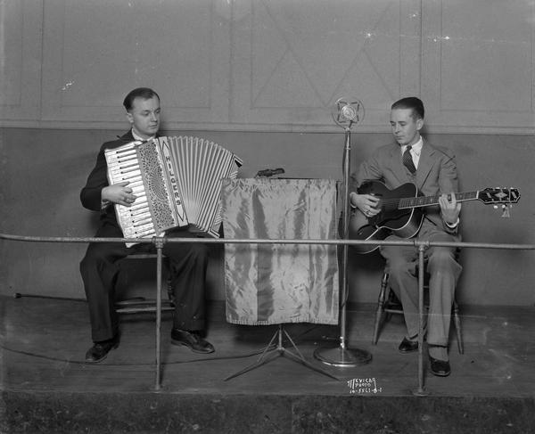 Man playing accordion and man playing guitar at the Town Club Tavern, located at 2501 Sherman Avenue.
