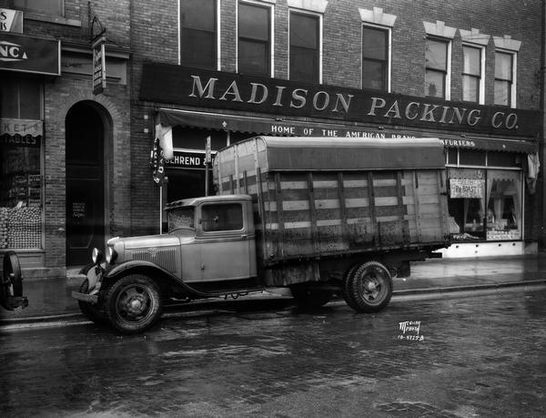 Ford truck outside in the rain at the Madison Packing Company, located at 307 West Johnson Street.