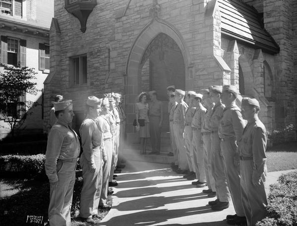 Theodore E. Christianson and Bernice M. Huffman exiting from Bethel Lutheran Church after their wedding, 318 Wisconsin Avenue, with a military Arch of Honor by Truax soldiers.