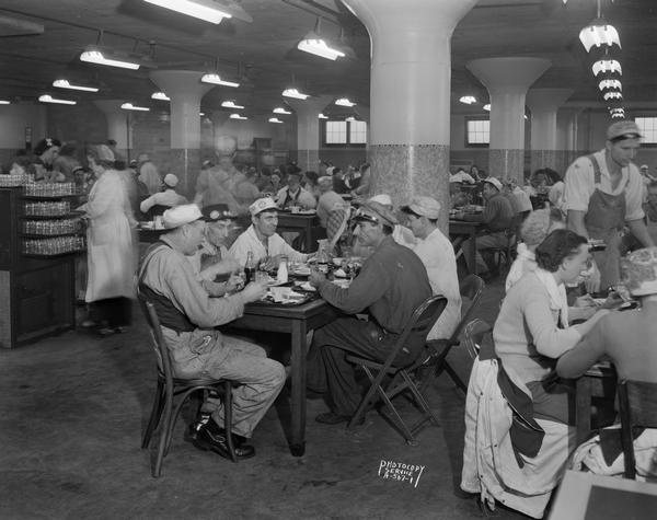 Oscar Mayer Company cafeteria with workers sitting at tables.