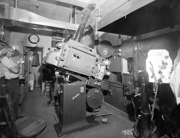 RCA Artcraft and IPC Simplex Cinemascope projector equipment in projection room with operators, at the Orpheum Theatre, 216 State Street.