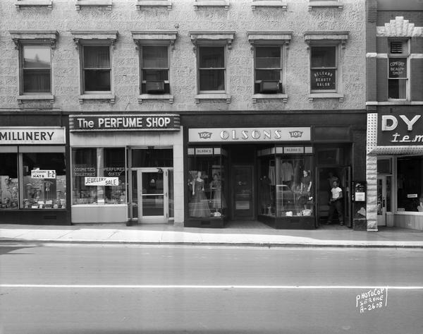 Exterior of stores on State Street, including Sandra Hat Shop, 101 State Street; The Perfume Shop, 103 State Street; Olson's Dress Shop, 105 State Street and Dyer's Shoe Store, 103 State Street.