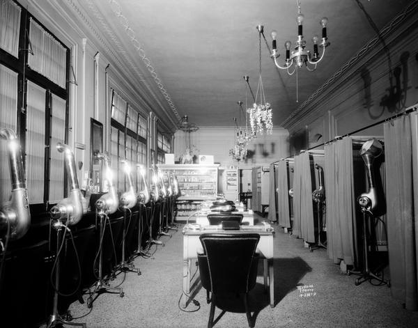 Interior corridor of the Cardinal Beauty Shop, located at 625 State Street, with hair dryers and manicure tables.