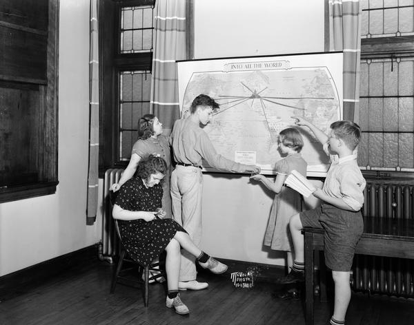 Five children looking at map of Presbyterian missions located throughout the world, at Christ Presbyterian Church, located at 124 Wisconsin Avenue.