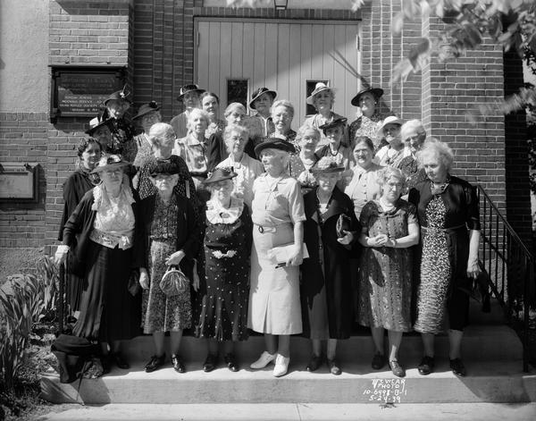 Group portrait of the Ladies Aid Society on the steps of Westminster Presbyterian Church, located at 1806 West Lawn Avenue. The view was taken on the 47th anniversary of their parent church, Christ Presbyterian Church.