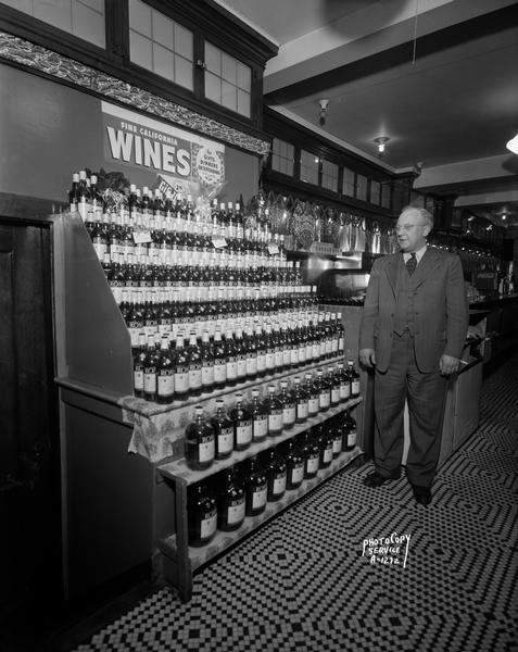 Roma wine display at Walgreen drug store, 32 East Mifflin Street, with store manager, Ernst Rintelmann.