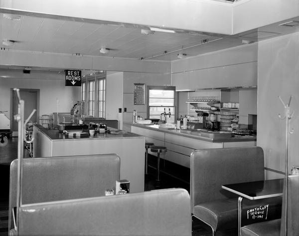 Interior of Roadside Milk Bar with soda fountain, service island, and booths. The business was located on Middleton Road (University Avenue), just before the entry to the Post Farm.