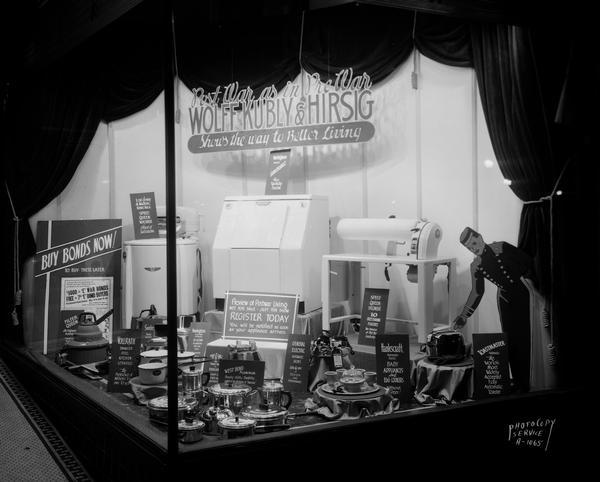 Window display at Wolff-Kubly & Hirsig, 17 South Pinckney Street, with post-war appliances including products by Vollrath, Filter Queen, West Bend, General Electric, Hankscraft, Toastmaster, Speed Queen, Westinghouse, Ray-O-Vac, Remington and Sunbeam.