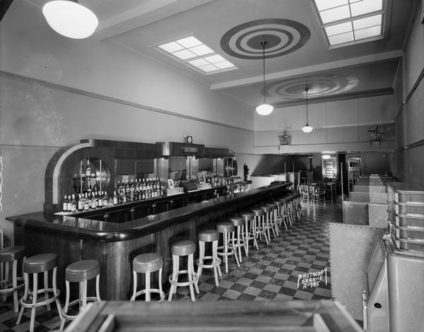Interior view of the Rex Bar, located at 546 West Washington Avenue, with bar and booths.