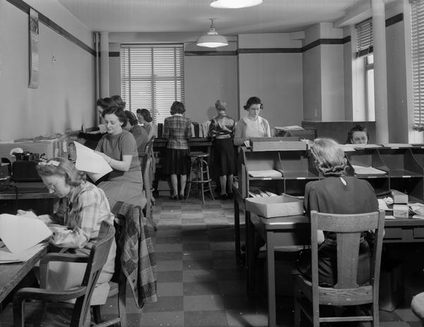 Women office workers in "one of the many extra offices needed to handle the rush for birth certificates" in the Wisconsin State Office Building (Capitol Annex), 1 West Wilson Street.