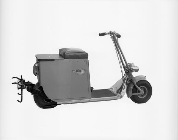 Keen Power Cycle, a streamline style motor scooter, made by Keen Manufacturing Company, located at 2117 Atwood Avenue. The view includes a trailer hitch and storage compartment behind the seat.