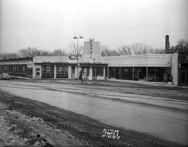 Olaf S. Jacobson Motors garage at 1501 Monroe Street (corner of Regent and Monroe Streets), featuring Pure Oil and Ford automobiles. This view was taken following Art Deco remodeling.