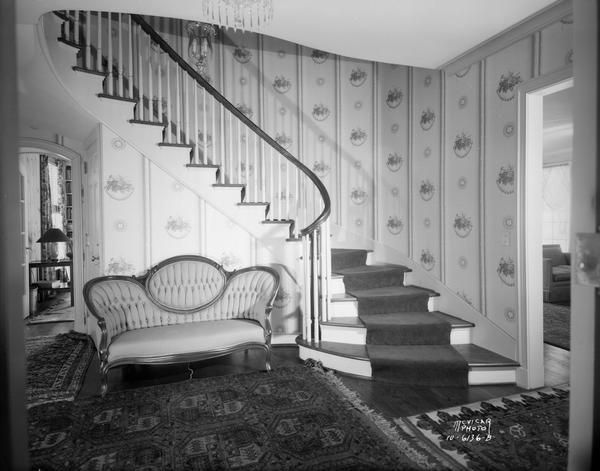 Stairway and entrance hall, with Victorian sofa, in Louis C. George home, located at 201 Farwell Drive.