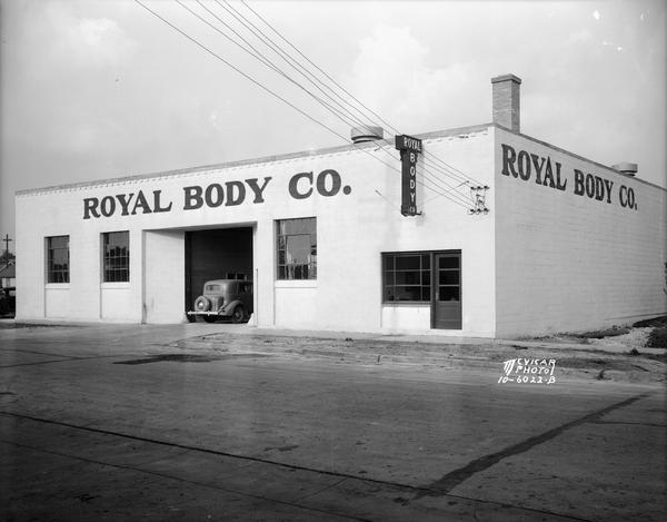 Royal Body Company building with automobile parked in the service entrance, 9 N. Brooks Street.