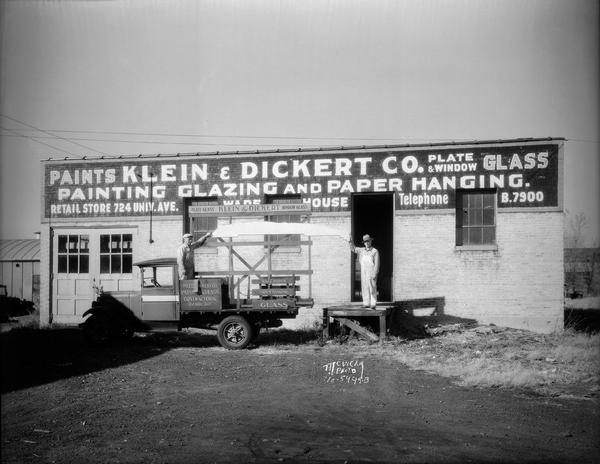 Klein Dickert Co. warehouse, 1130-32 Regent Street, with two workers loading glass panel onto truck.