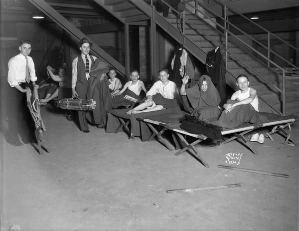 A group of high school musicians from Township High School, Joliet, Illinois, on sleeping cots in the Field House during a National School Music contest.