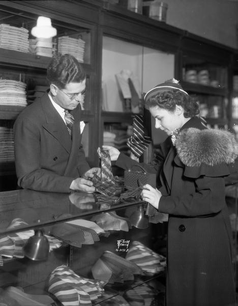 A man is selling neckties to blues singer Emerie Ann Lincoln, at Spoo & Stephan Store, 18 N. Carroll Street.