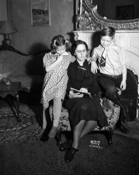 Mrs. Phillip (Isabel) La Follette reading to Bob and Judy, her children, at the Governor's Residence, 130 East Gilman Street.