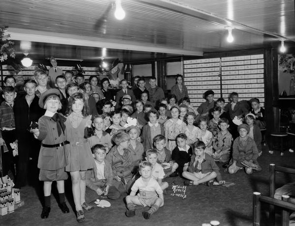 Group portrait of more than 40 children with Buster Brown at 'Buster Brown' party at Burdick and Murray Department Store.