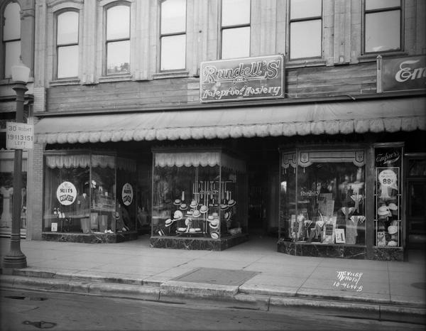 Rundell's Inc., men's clothing store, 9 East Main Street. The view includes part of the Empress Hat Shop on the right.