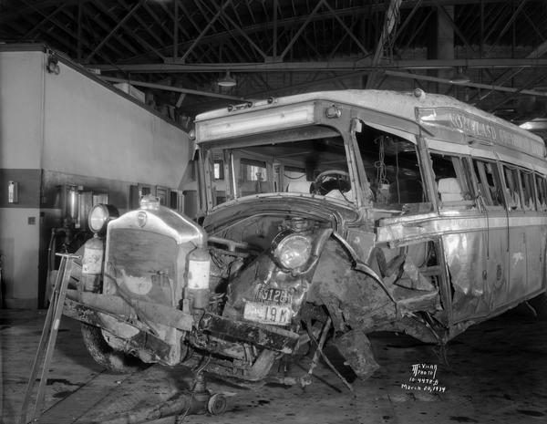 Damaged Northland Greyhound bus No. 695, left front view, in garage at 102 South Brearly Street.