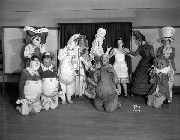 Girls dressed like 11 "Alice in Wonderland" characters for the "Hollywood Revue" being produced by the Beth Jacob sisterhood.