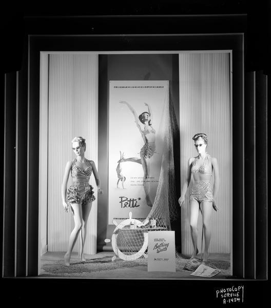 Manchesters Inc. display window containing two mannequins wearing "Petti" bathing suits, and a life-size poster of a girl in a "Petti" bathing suit.
