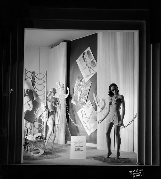 H.S. Manchesters Inc. display window (#4)featuring two mannequins in Jantzen bathing suits, and three posters showing women in Jantzen bathing suits.  Sign says: "Jantzen puts a fresh new look on American beaches."