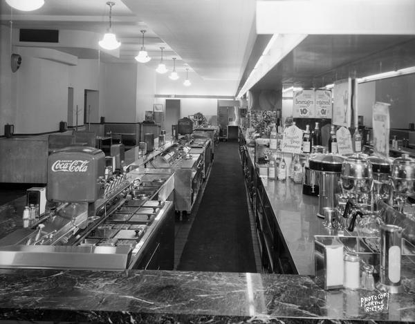 Soda fountain of Rennebohm Drug Store #10, 676 State Street, from end showing back bar, and also showing the booths in the background.