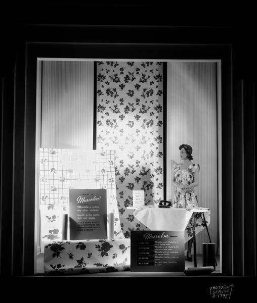 Marvalon display window, H.S. Manchester's Incorporated, 2 East Mifflin Street, with a mannequin ironing a sample of Marvalon, "A tough plastic film reinforced and strengthened with a fiber backing."