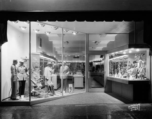 Exterior of Speth's Clothing Store, 222 State Street, with large display windows. To show lighting.