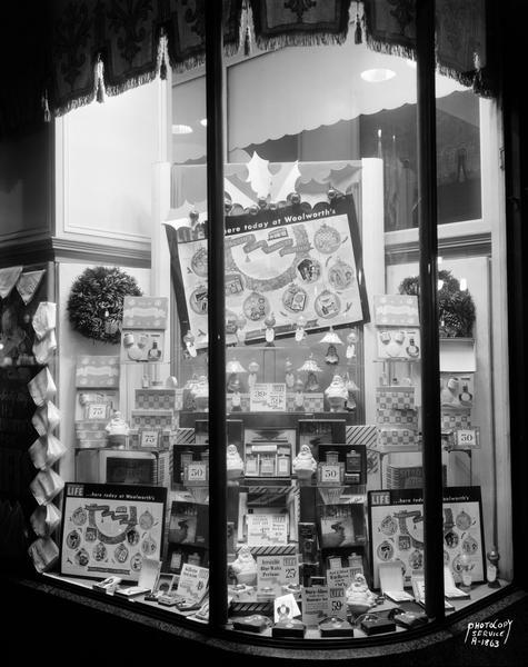 Close-up of F.W. Woolworth Company, 1-7 East Main Street, Christmas gifts window. Life advertising products.
