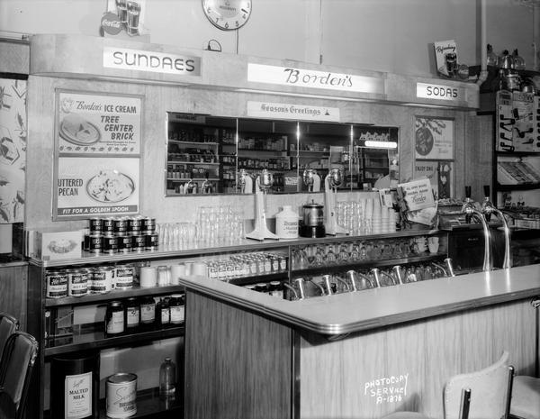 Lawson Drug Store interior, view of the soda fountain, featuring Borden's ice cream products.