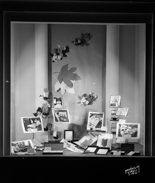 Store window of H.S. Manchester Inc., 2 East Mifflin Street, featuring Crane stationery. Sign reads: "The Here's How of Crane fine stationery." Photographs in the window show people making stationery.