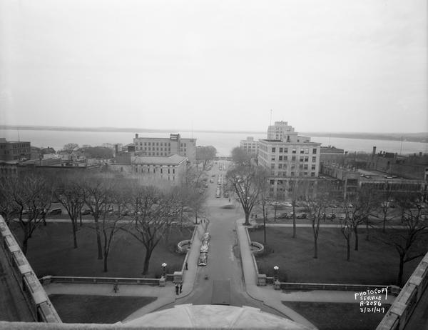 Elevated view from Wisconsin State Capitol, showing Main Street side of square, looking down Monona Avenue (Martin Luther King, Jr. Boulevard). Buildings include Pioneer Building, Beaver Insurance Building, Union Trust Company bank building and State Office Building.