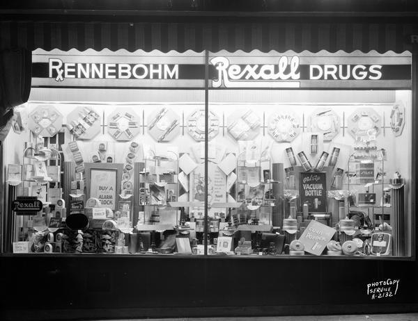 Rennebohm Drug Store #2, 204 State Street, display window featuring school supplies, alarm clocks, vacuum bottles, and corn poppers, all items that would be needed by University students who comprised a large portion of the customers of this store.