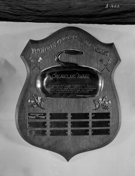 Twentieth Century Press Trophy, Chicagoland Award; presented by Paul C. Clovis, president of the Twentieth Century Press of Chicago, to winners of the Midwest Association's Annual Bonspiels for the encouragement, good sportsmanship, interest, and participation in the ancient Scottish game of curling. Presented to members of the Madison Curling Club of 1946; H.H. Puetz (skip), W.S. Sherlock, G.C. McNaughton, I.C. Davis.