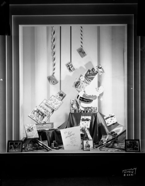 Window display at H.S. Manchester's, Incorporated, 2 East Mifflin Street, featuring Tie-Tie gift wrapping supplies, "Learn the art of gift wrapping," taken for Chicago Painted String Company.