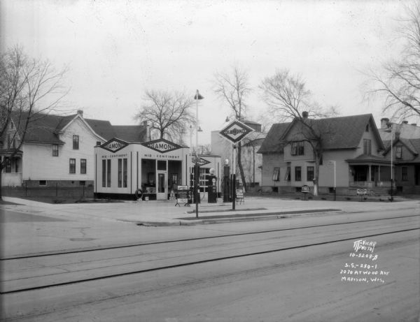 Diamond Service Station (Mid Continent Petroleum Corp.), 2070 Atwood Avenue, corner of Rusk Street,  Schenk's Corners, with houses in the background.