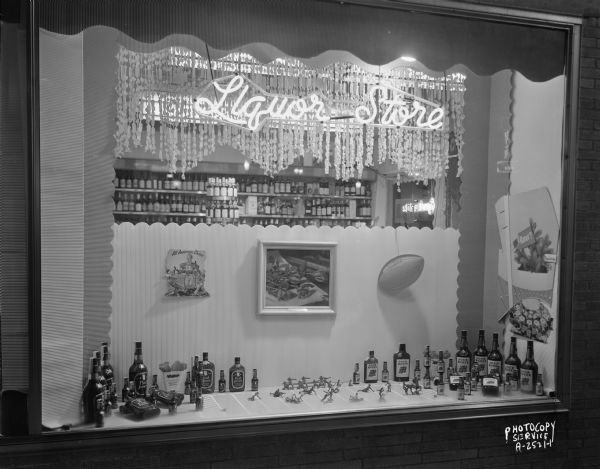 Corona Liquor Store, 201 West Mifflin Street, "Football window" featuring Paul Jones and Four Roses liquor bottles, sign "All American Choice," and small figures of football players.