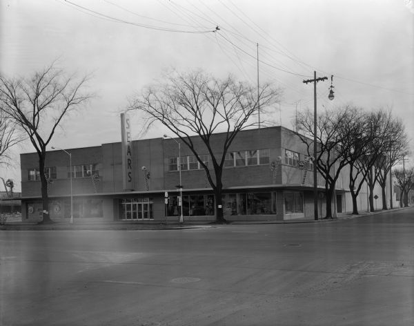 Exterior view from the west of Sears Roebuck and Company store at 1101-1115 East Washington Avenue, with Christmas decorations, located on the corner of East Washington Avenue and South Ingersoll Street.