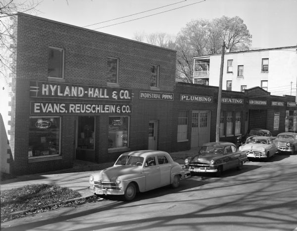Exterior view of 212-218 North Bassett Street, Hyland-Hall & Company (plumbing, heating and sheet metal contractors) and Evans, Reuschlien & Co., electrical contractors, Division of Hyland-Hall & Company.