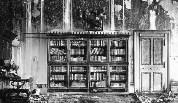A close-up of the damage in the office of the Superintendent of Public Instruction caused by the Wisconsin State Capitol fire. Details of interest include the bookcase, which miraculously escaped destruction, and the interior door.