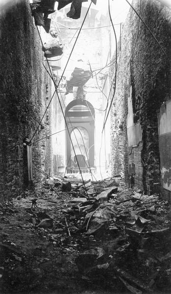 Second floor corridor of the South Wing of the third Wisconsin State Capitol, looking south, after the fire of February 27, 1904. The view is through the central Rotunda showing the balustrade around the gallery.